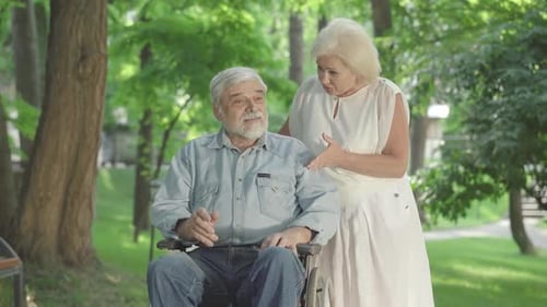 Senior Couple in Park Conversing Lovingly