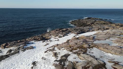 Winter Aerial Flight Top Over Waves Rolling on Artic Ocean Shore with Round Stones Ocean Waves at