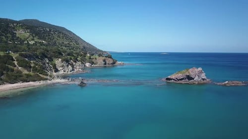 Amazing Blue Water of Warm Sea Near Rocks of Coast in Sunny Day, Aerial View