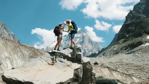Backpackers Celebrate Peak of Mountain Adventure
