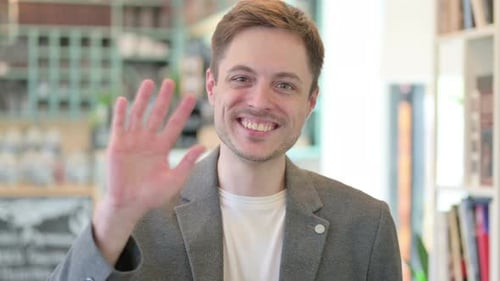 Portrait of Young Man Waving Welcoming