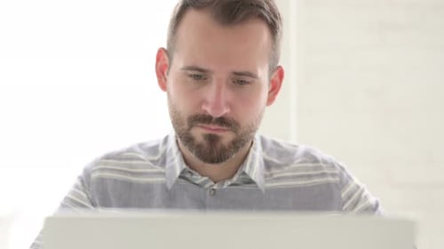 Close Up of Man Working on Laptop