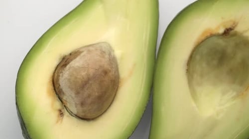 Avocado Slices Closeup, Macro Food Summer Background, Fruits Top View. Rotate