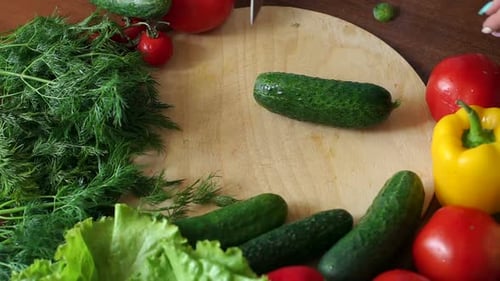 Slicing a Cucumber with Fresh Vegetables