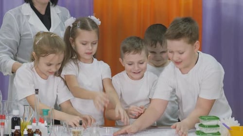 Kids Doing Science Experiment with Teacher in Classroom