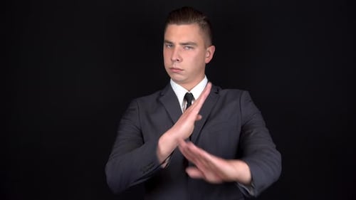 Young Adult Shows No with Arm Gesture