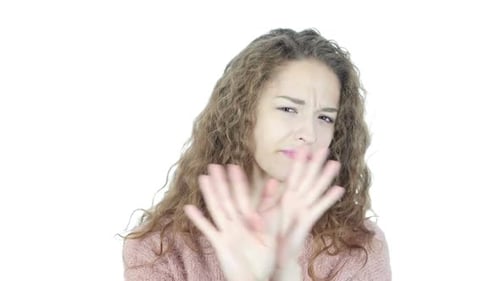 Woman Declines with Hand Gesture on White Background