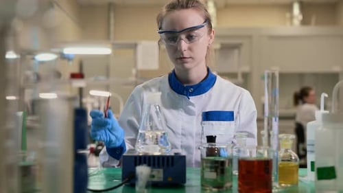 Woman Scientist Conducts Experiment in Laboratory