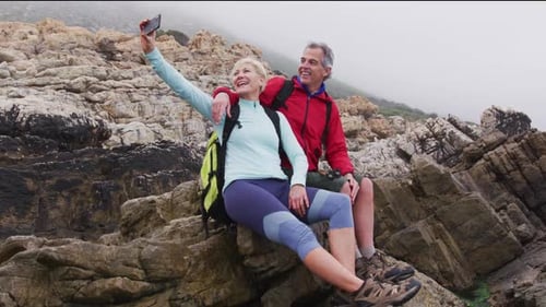 Couple on Rocky Coastline Take Selfie