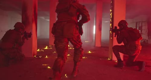 Armed Soldiers Maneuver Through Burning Building