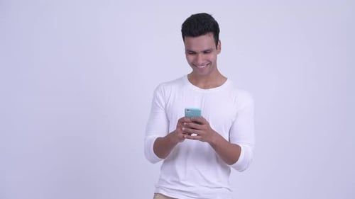 Young Man Using Smartphone, Thinking
