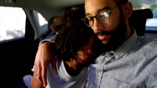 Affectionate Couple Embracing in Car Sharing Mobile Phone