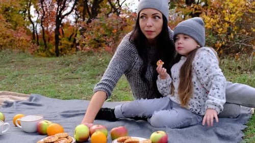 Mom and Threeyearold Daughter in the Park on a Picnic