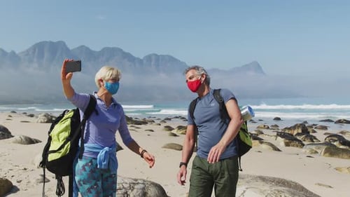 Couple on Beach Take Selfie in Masks