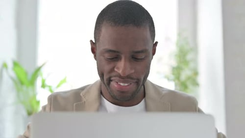 Close Up of African Man Working on Laptop