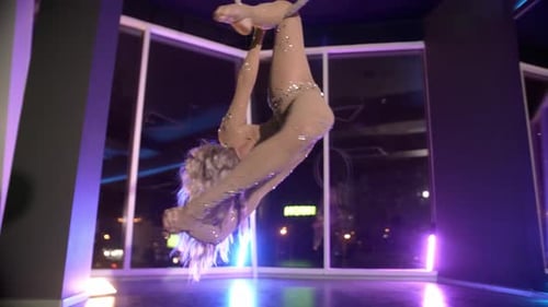 Blonde Woman Performs Aerial Acrobatics on Hoop