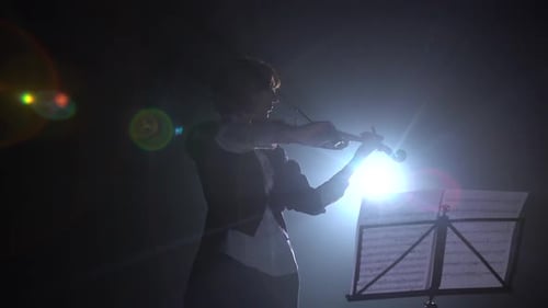 Violinist Plays in Dramatic Dark Silhouette