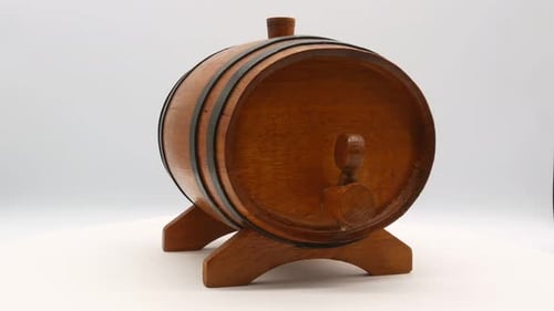 Wooden Barrel Rotating on a White Surface
