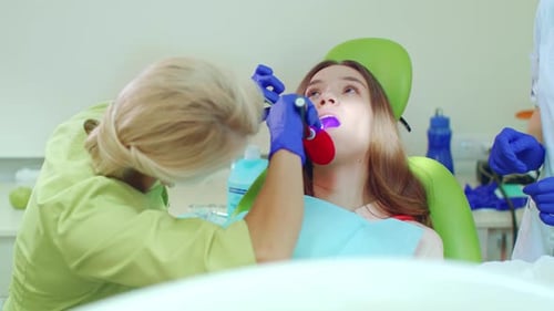 Dentist Treating Patient in Bright Medical Office