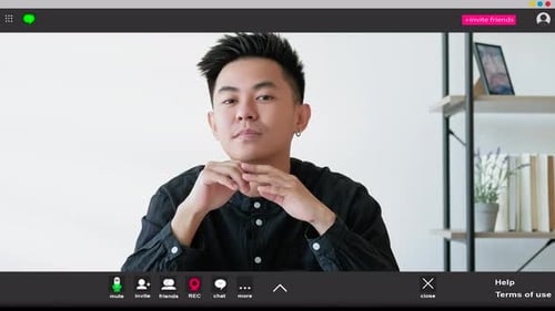 Man Participates in Virtual Meeting from Home