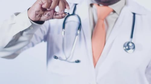 Doctor Writing on Clear Surface About Health