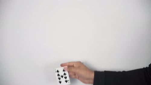 Hand Performing a Card Trick on White Background