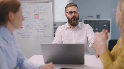 Colleagues Collaborate During Office Meeting