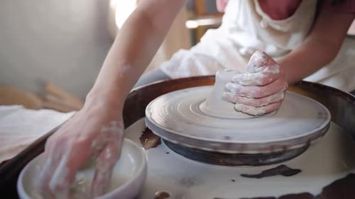 Art Class in Pottery Woman is Learning to Work with Pottery Wheel