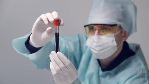 Medical Professional Analyzing Blood Sample in Test Tube