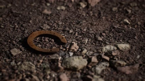 Rusty Horseshoe on Rocky Ground Slow Zoom Out