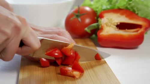 Dicing Red Bell Pepper on Wooden Cutting Board