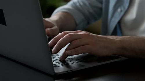 Working on laptop computer, Men's hands typing on keyboard, modern office business