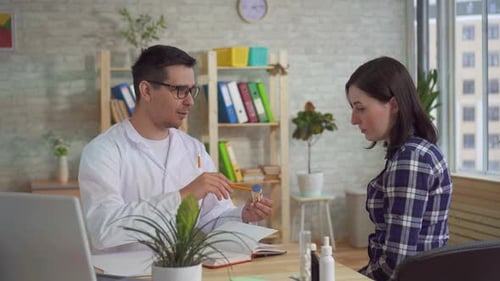 Doctor Consulting Patient in Medical Office