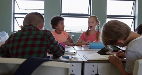 Children Studying and Talking in Classroom Setting