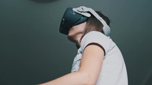 Woman Experiencing Virtual Reality with Headset and Controllers