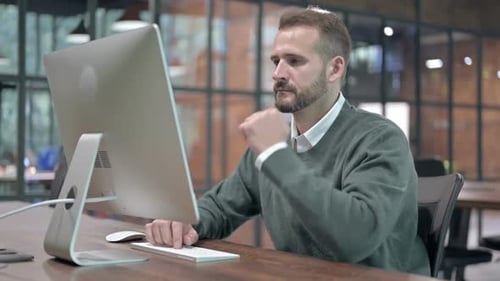 Tired Man Having Quick Nap at Office Desk