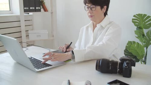Woman Using Graphics Tablet with Laptop and Camera