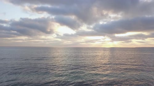 Man standing on the beach and holding his arms up. Man celebrating on the beach with hands in victor