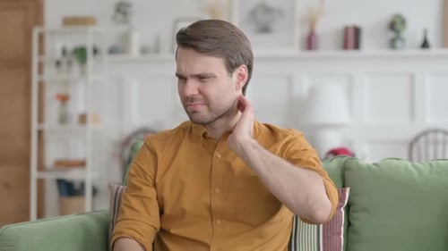 Man Experiencing Neck Pain at Home