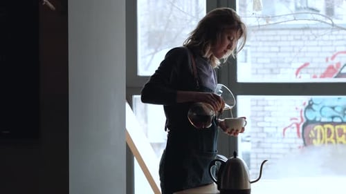 Young Adult Making Coffee in an Urban Cafe