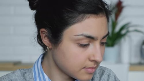 Close Up of Young Woman with Dark Hair Indoors