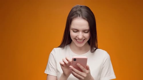 Young Woman Using Her Smartphone in Studio