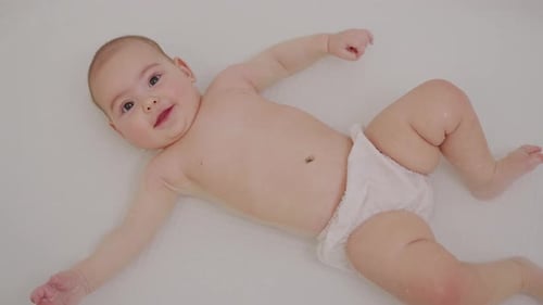 Delightful Baby Smiles in White Bathtub