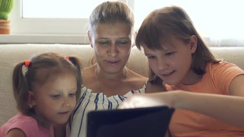 Woman and Children Using Tablet at Home