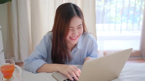 Woman Typing on Laptop in Bright Home Interior