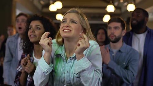 Friends React to Sporting Event at an Indoor Venue