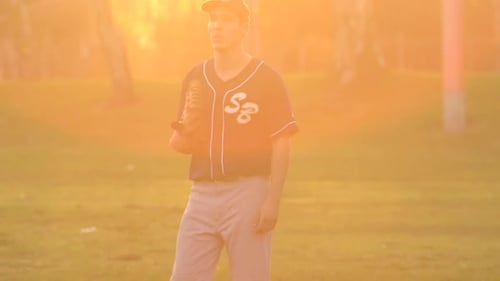 A young man playing catch with a baseball.