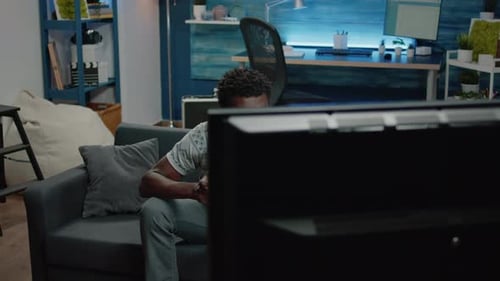 Man Relaxing and Playing Video Games at Home