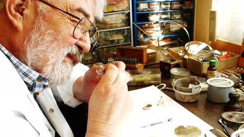 Horologist repairing a watch