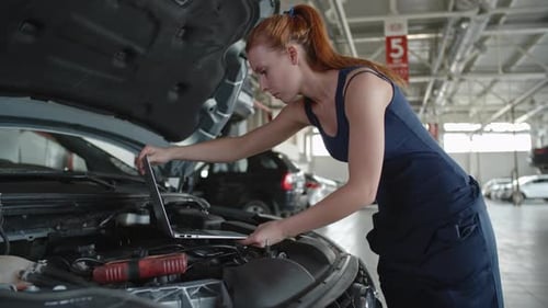 Woman Testing Car with Laptop